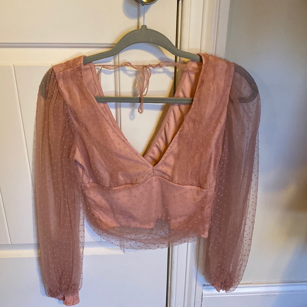 Adorable mesh overlay shirt! With a v neck dip in the front and back!